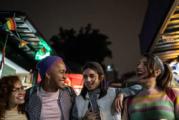 istock Friends talking outdoors at night - including a transgender person 1415631151