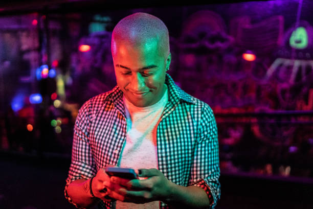 istock Young man using the mobile phone at nightlife 1415633820