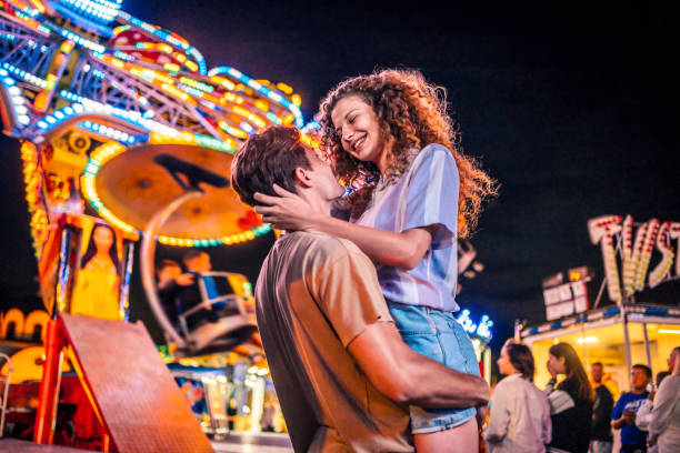 istock Young couple enjoying at the amusement park 1415634125