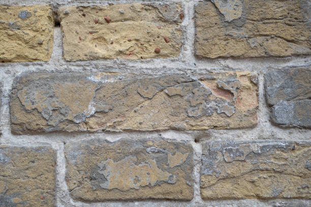 istock Wall of old yellow bricks. Vintage background 1415634895