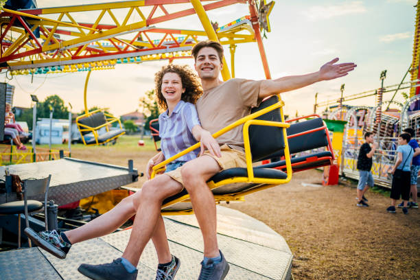istock Couple having fun in an amusement park 1415635140