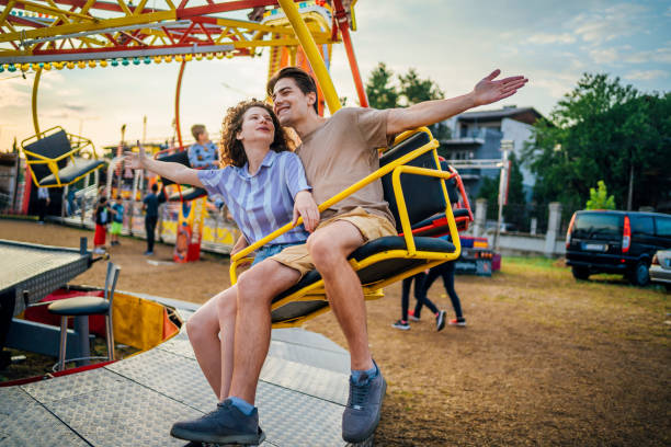 istock Couple having fun in an amusement park 1415635706