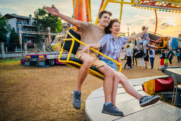 istock Couple on the carousel in an amusement park 1415635741