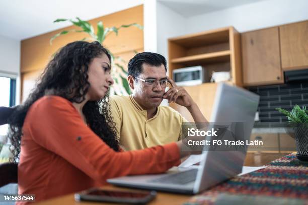Worried Couple Using Laptop Doing Home Finances Stock Photo - Download Image Now - Couple - Relationship, Emotional Stress, Worried