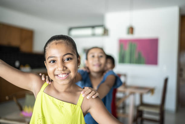 istock Siblings playing and running around the house 1415638343