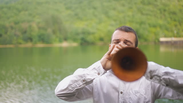 A Look In The Hole Of A Zurna Traditional Instrument While Being Played By Male Next To Lake