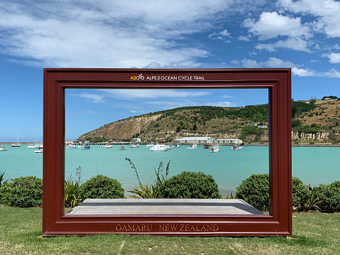 A huge picture frame sign at Friendly Bay and Holmes Wharf in historic town Oamaru, New Zealand.