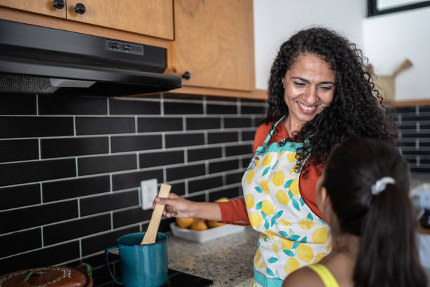 istock Mother and daughter cooking at home 1415639655
