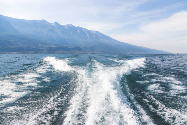 istock Boat tour: Boat bow, view over azure blue water and mountain range. Lago di Garda, Italy 1415639821