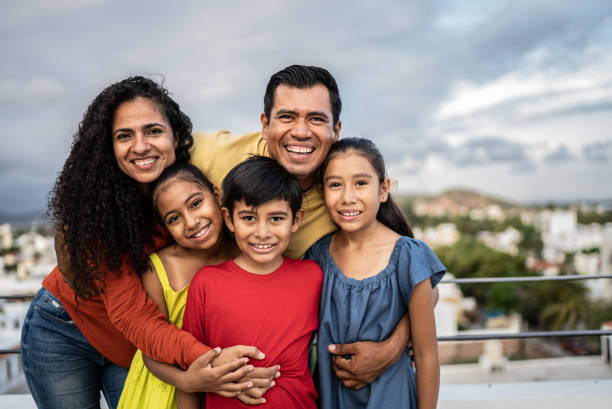 Portrait of Mexican family outdoors stock photo