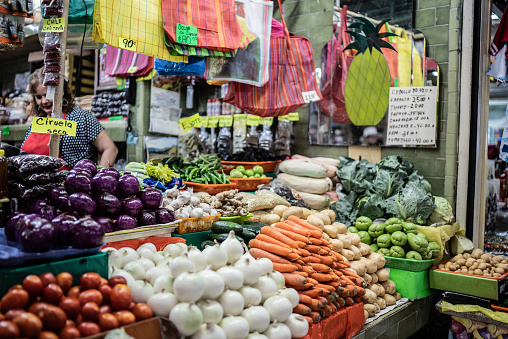 People shop for fresh fruit and vegetables at an open-air market. Turkish bazaar with fresh and ripe fruits and vegetables.