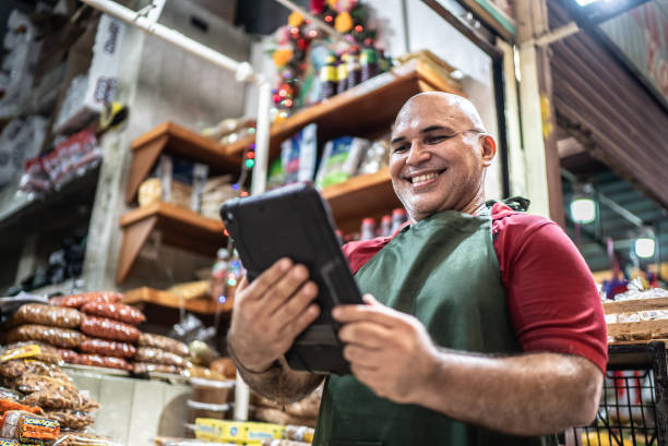 istock Mature man small business owner using digital tablet 1415643332