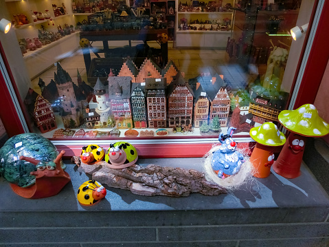 Frankfurt am Main, Germany - April 20, 2022: Souvenir shops with different goods, view through the glass.