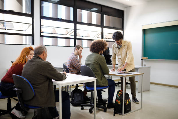 istock Professor giving advice on an exercise to his students 1415644312