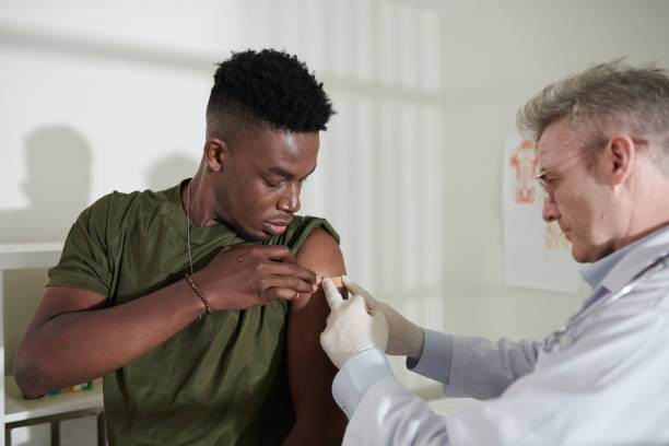 istock Sticking Bandage on Vaccine Injection Site 1415644385
