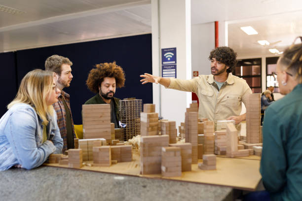 istock Professor explaining about the city maquette to his students 1415644408