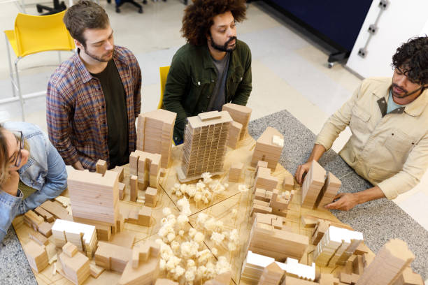 Professor explaining about the buildings with a city model
