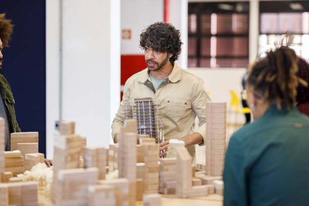 istock Professor holding a polished building model 1415644443