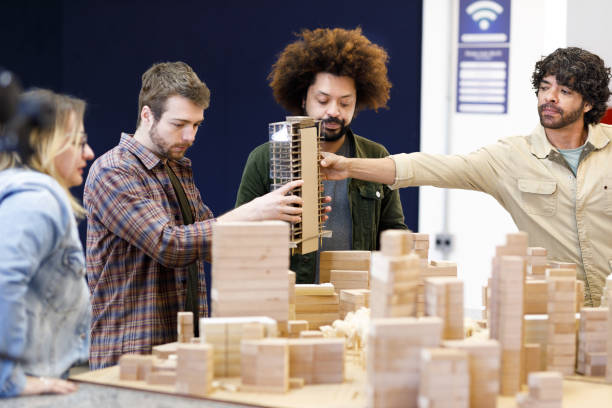istock Professor handing a polished building model to the student 1415644484