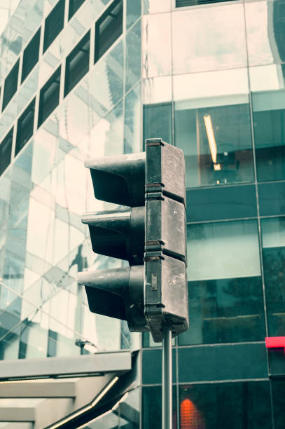 istock Traffic light close up on modern building background 1415644488
