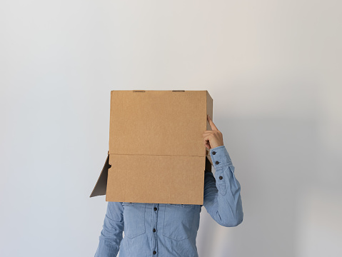 Person with box on head and hand touching box