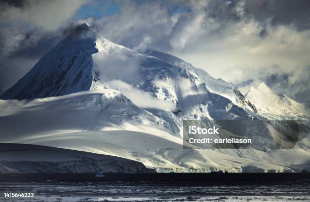 Towering Mountain In Early Antarctic Sunlight Stock Photo - Download Image Now - Antarctica, Landscape - Scenery, Polar Climate