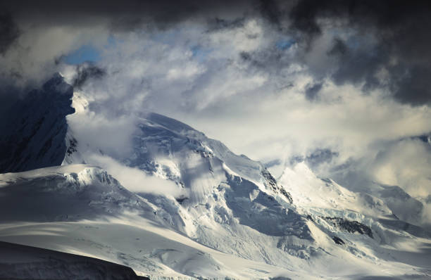 istock Rugged Mountains in Antarctic Shrouded with Clouds 1415646293