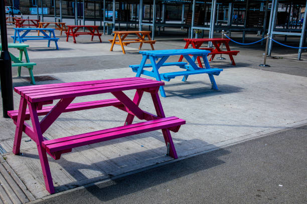 istock Colourful picnic benches in market Square 1415647239