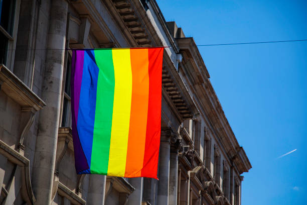 istock LGBTQ Flag on Side of old building 1415647462