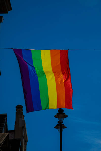 istock LGBTQ Flag flying in blue sky 1415647531