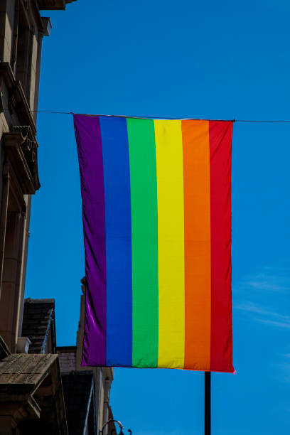 istock LGBTQ Flag flying in blue sky 1415647542