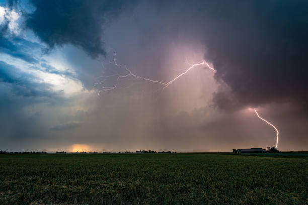 istock Wide angle view of lightning in a thunderstorm at sunset 1415648706