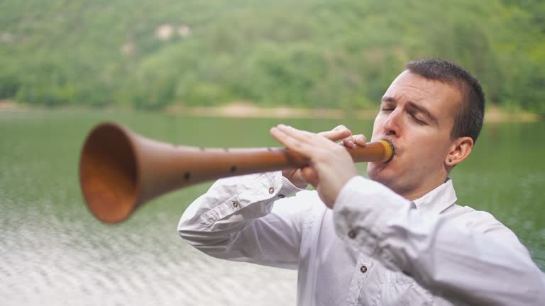 Mountain Lake Fun For Male Folk Musician Playing Zurna Instrument