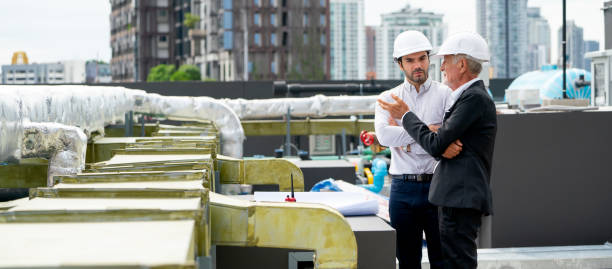 istock Senior man explain about project to his coworker as engineer of construction site. 1415649398