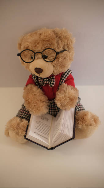 istock Teddy Bear in eyeglasses with book. 1415649440