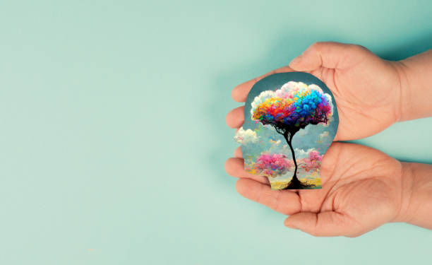 istock Holding a head with a colorful tree in the hands, symbol for creativity, connection to nature and positive emotion, living in a dream world 1415650089