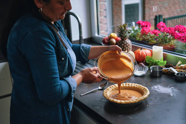 istock Preparing Pumpkin Pie for the Holidays in Domestic Kitchen 1415650523