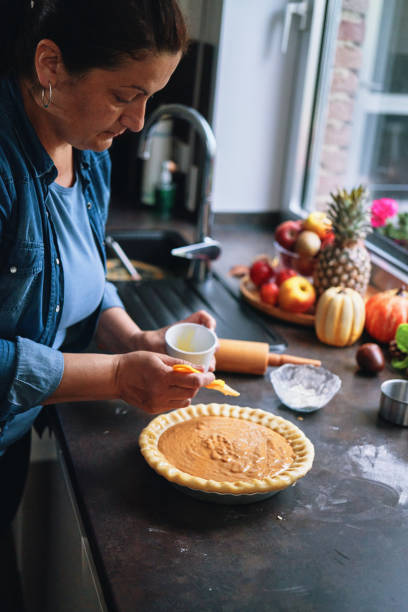 istock Preparing Pumpkin Pie for the Holidays in Domestic Kitchen 1415650529