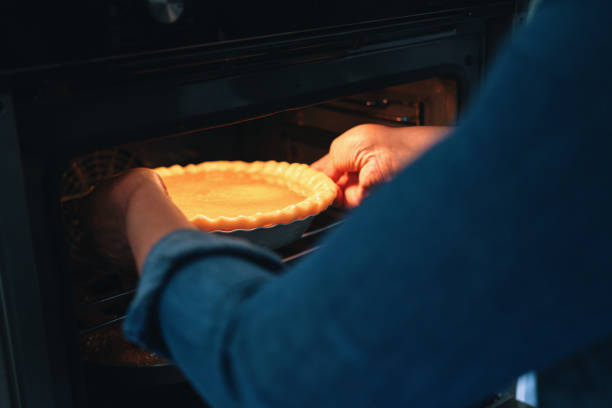 istock Baking Pumpkin Pie for the Holidays in the Oven 1415650541