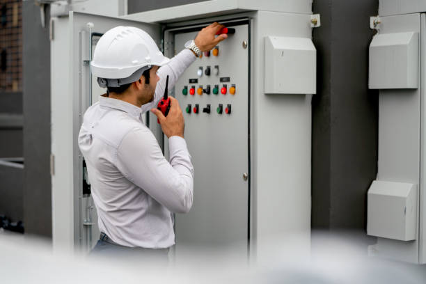 istock Caucasian engineer man or technician using walkie talkie to contact his coworker and ask for support about electrical control panel in construction site. 1415650623