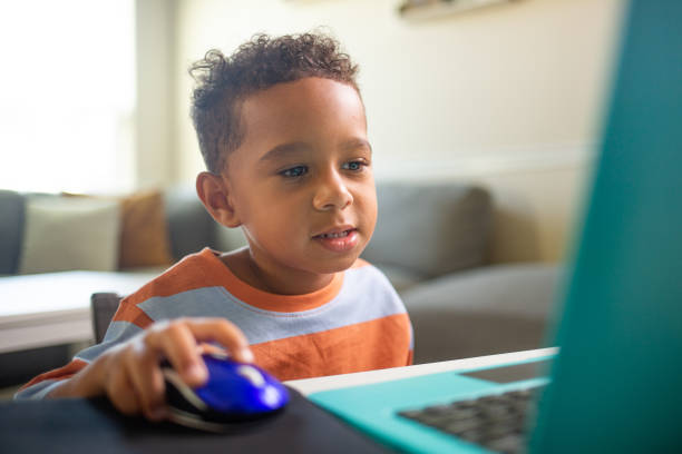 istock Talking Wide Mixed 3 year Old Boy learning on the Laptop Computer 1415650676