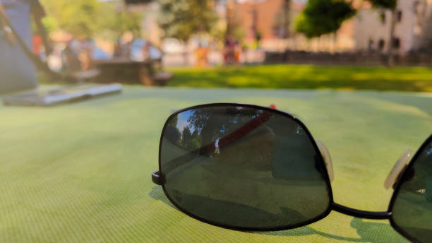 sunglasses on table with out-of-focus background and copy space concept rest relax relax