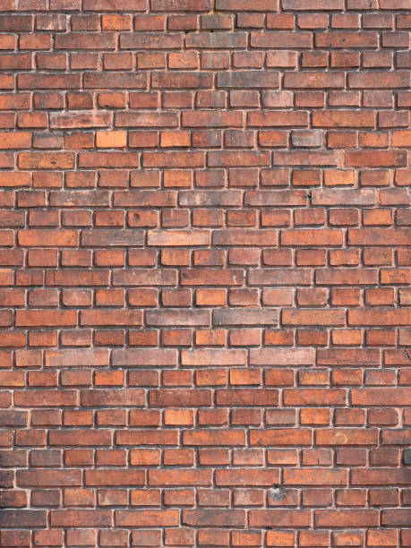istock Brick wall background. Pattern brown color design decorative uneven cracked real stone wall surface with cement. Dry brick wall as seamless background 1415657123