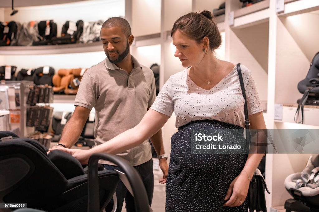Mixed Race pregnant couple shopping for baby supplies Mixed Race pregnant couple shopping for baby supplies for their new home Pregnant Stock Photo