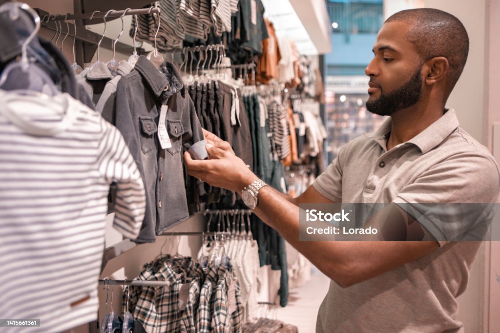 Handsome mixed race father shopping for baby supplies 30-34 Years Stock Photo