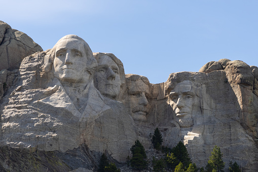 Mount Rushmore National Monument in South Dakota with carvings of George Washington, Thomas Jefferson, Theodore Rosevelt, and Abraham Lincoln a symbol of freedom and patriotism.