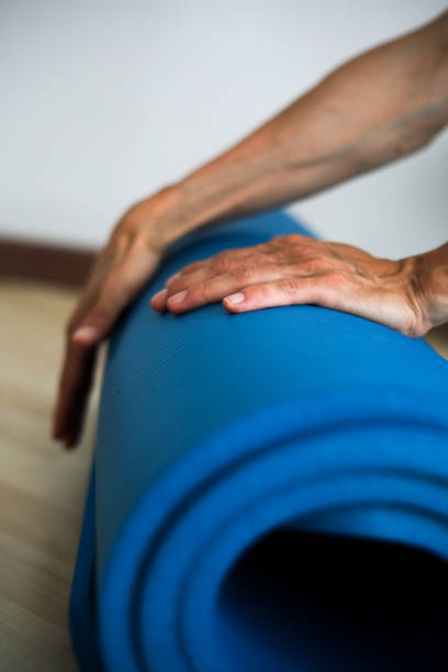 istock hands with yoga mat 1415666411