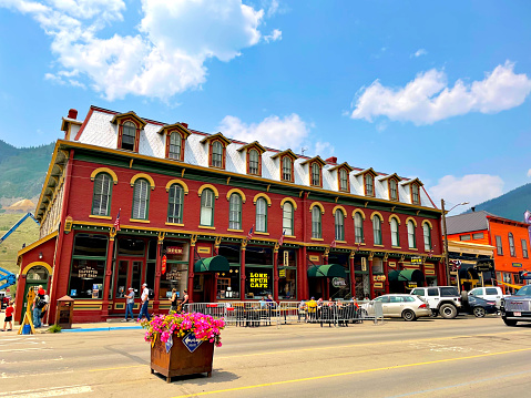 Silverton, Colorado, USA - July 12, 2021: Tourists enjoy the afternoon in historic Silverton while window shopping and eating at local restaurants in the downtown district.