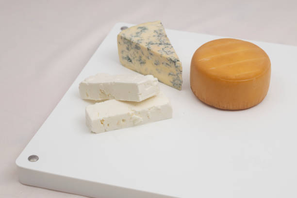 istock Three types of cheeses on white proffesional chopping board 2 1415669510