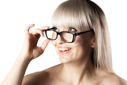 Portrait of a beautiful brunette girl with blond bangs fringe. Wearing glasses.